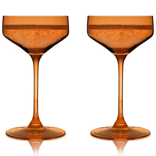 AMBER COUPE COCKTAIL GLASSES – This set of amber colored cocktail coupes will enhance your shaken cocktails. A sleek silhouette with an angled bowl gives these colored coupe glasses a contemporary look, while the amber hue recalls vintage glassware.