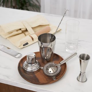 6 ESSENTIAL COCKTAIL TOOLS - These bar tools are the backbone of any home bar. Includes a classic cobbler cocktail shaker, Hawthorne strainer, sturdy bottle opener, double-sided jigger, spiral barspoon, beechwood muddler, and canvas carry bag.
