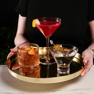 STAINLESS STEEL WITH GOLD PLATED FINISH - Crafted from sturdy stainless steel, this round serving tray measures 12.5″ across, has a smooth 2 inch rim to help keep your drinks steady while you transport them, and is plated in shiny, luxe gold.