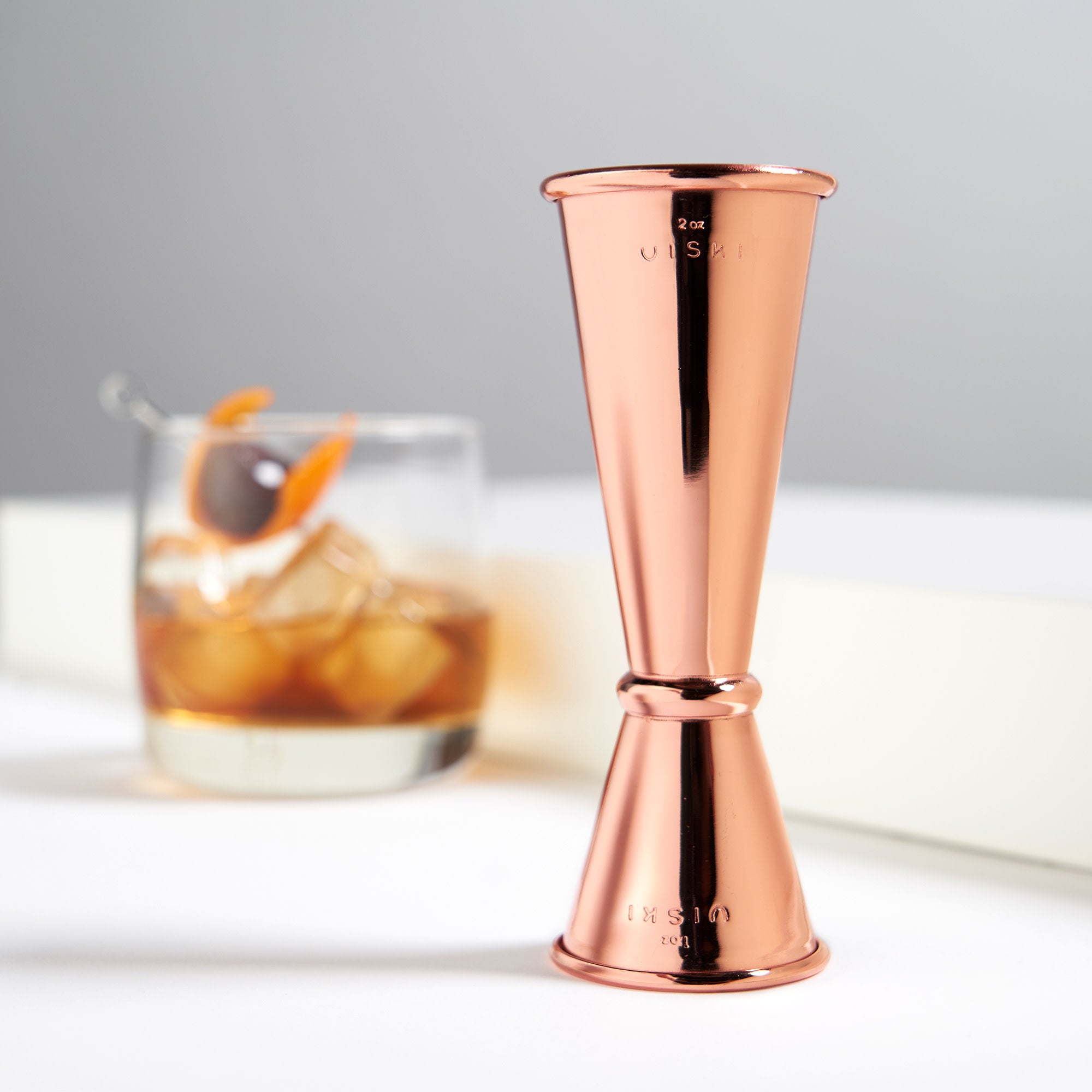 copper-finished japanese jigger with measurements inside-cocktail