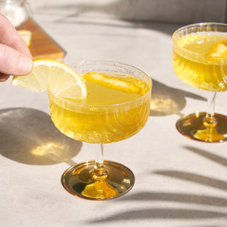 HIGH-QUALITY GLASS WITH GOLD ACCENTS – This beautiful crystal-clear glass set is crafted for a high-end sipping experience. Sleek draping glass and a gold-plated foot give this barware timeless elegance—perfect for serving your finest liquor.
