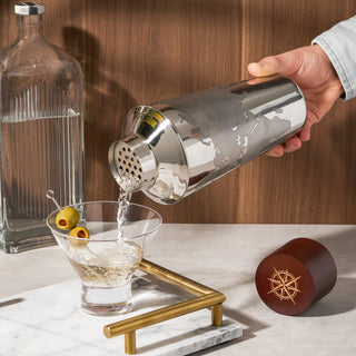 QUALITY BAR SHAKER - Crafted from high-quality polished stainless steel with sanded details, this bar tool includes a built-in strainer and brings decadence to your cocktail experience. The wooden cap is etched with a compass, completing the look.