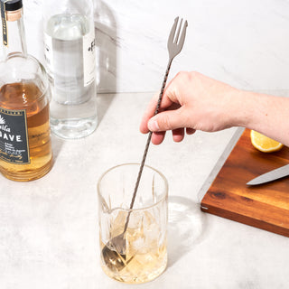 BAR MIXING SPOON WITH TRIDENT TIPPED END - The fork tipped end of our bar spoons make it easier for you to spear the perfect garnish to cap your cocktails. Cocktail stirring spoons will elevate your home bartending with panache.