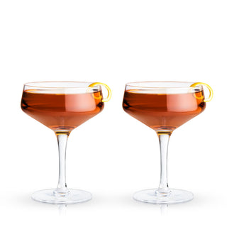 COUPE GLASSES FOR CONNOISSEURS - This recognizable classic cocktail glass makes a refined addition to anyone’s at-home bar set or kitchen. Arguably a barware essential, this set of stemmed coupe cocktail glasses elevates your cocktail game.