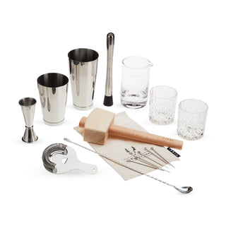 ULTIMATE BAR TOOL SET - This barware set includes a Boston shaker tin set, double jigger, muddler, mixing glass, Hawthorne strainer, twisted bar spoon, 2 crystal old fashioned glasses, Lewis ice bag and wooden mallet, and 6 silver drink picks.
