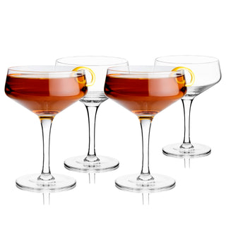 COUPE GLASSES FOR CONNOISSEURS - This recognizable classic cocktail glass makes a refined addition to anyone’s at-home bar set or kitchen. Arguably a barware essential, this set of stemmed coupe cocktail glasses elevates your cocktail game.