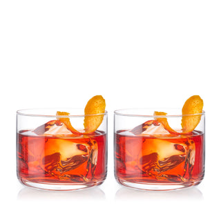 CRYSTAL NEGRONI GLASS SET – This beautiful pair of cocktail glasses has a heavy, rounded base and smooth silhouette for a modern look. Designed specifically for the unique Negroni, this tumbler glasses set looks great in the hand or on a bar cart.