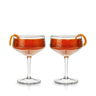 COUPE GLASSES FOR CONNOISSEURS - This recognizable classic cocktail glass makes a refined addition to anyone’s at-home bar set or kitchen. A barware essential, this set of stemmed coupe cocktail glasses elevates your cocktail game.
